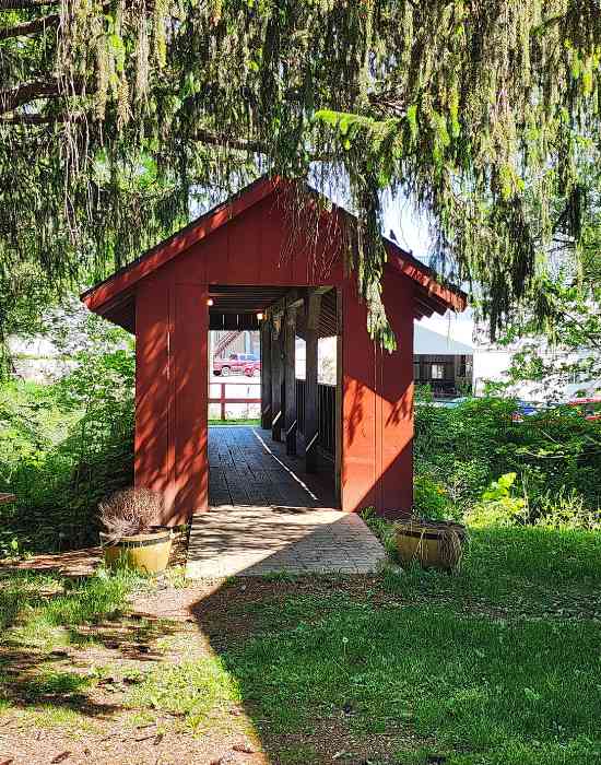 A walking bridge leading from a parking lot, across Indian Creek, to Paradise Cove.