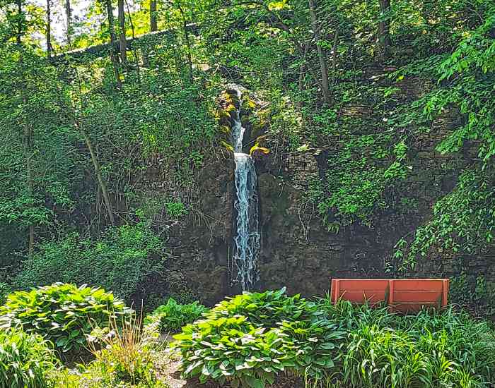 Waterfall and bench at Paradise Cove in Winslow IL. May 2024.